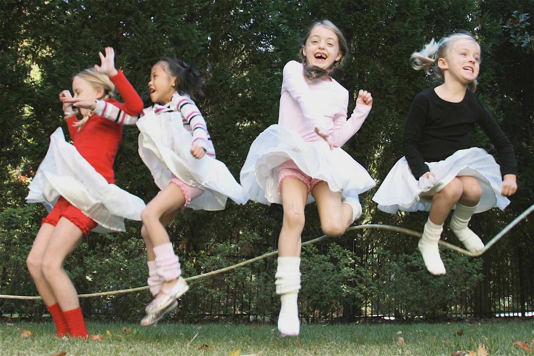 Child playing jump rope outdoors